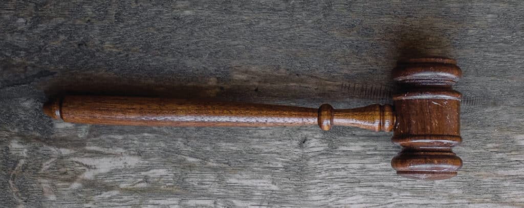 brown wooden gavel on a gray table